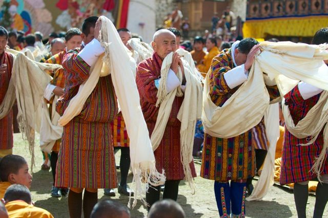 Worshipping in the presence of the Thangka, one of the most religious and precious items in Bhutan