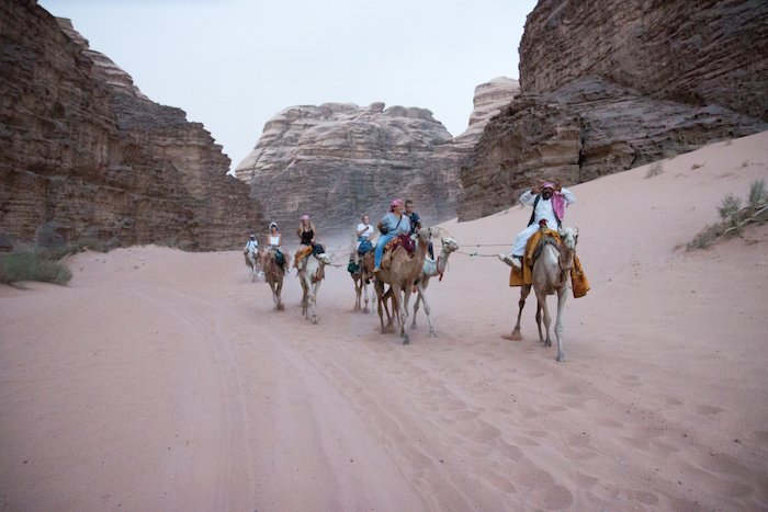 Tourists riding camels in Wadi Rum Desert Jordan